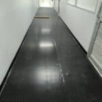 Black rubber flooring suitable for hallways and commercial spaces.