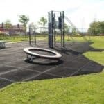 Rubber surface flooring at outdoor playground, durable and safe for children.