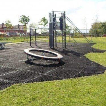 Rubber surface flooring at outdoor playground, durable and safe for children.