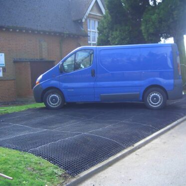 Flexible interlocking plastic floor mats for vehicle parking and driveway protection.