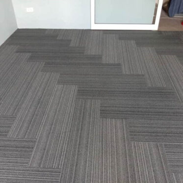 Plank carpet installed with herringbone pattern