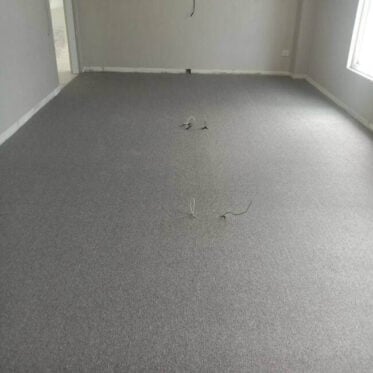 Grey carpet flooring installed in a modern room, ready for commercial or residential space renovation.