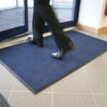 Non-slip blue rubber floor mat at building entrance; ideal for commercial and residential use.