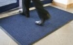 Non-slip blue rubber mat at the entrance.