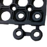 Flexible rubber flooring mat with circular cutouts for indoor or outdoor use.