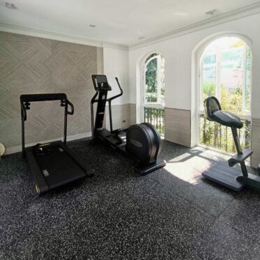 Gym flooring installation for condo and office spaces, durable slip-resistant surface.