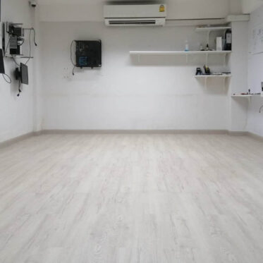 Polished light wood flooring in office or condo interior.