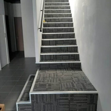 Installation carpet tiles on the stairs
