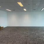 Office flooring installation with patterned carpet tiles in a clean, modern room.