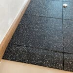Black speckled random pattern flooring tiles for modern condo interiors and offices.