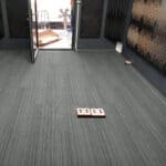 Eco-friendly striped carpet flooring for office or condominium interiors, showcasing professional installation.