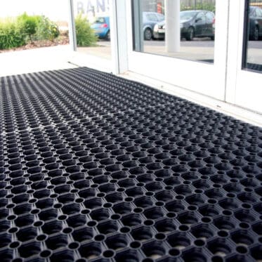 Black interlocking floor mat, durable and easy to install for indoor and outdoor spaces.