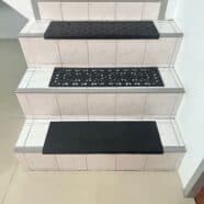 Black rubber stair treads with textured and decorative patterns for safety and style.