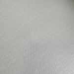 Smooth light grey flooring material with fine textured surface.