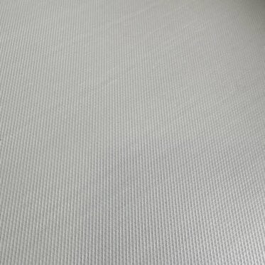 Smooth light grey flooring material with fine textured surface.
