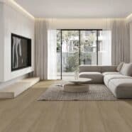 Smooth wooden flooring in modern living room with large window and minimalist decor.