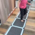 Flexible anti-slip flooring tiles demonstration in a showroom artificial flooring product display for homes and offices.