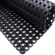 Flexible black drainage mat with hollow hexagon pattern for flooring projects.