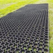 Heavy-duty plastic ground grid for lawn and garden drainage, easy to install.