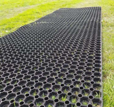 Heavy-duty plastic ground grid for lawn and garden drainage, easy to install.